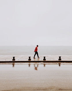 Man on beach against sky