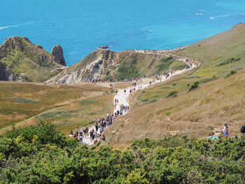 High angle view of people on shore by sea