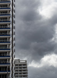 Modern buildings in city against cloudy sky