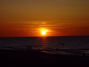 View of calm beach at sunset