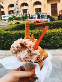 Close-up of hand holding ice cream cone