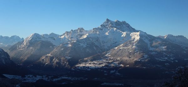 Scenic view of snowcapped mountains against clear sky