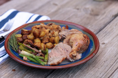 Roasted duck in plate on wooden table