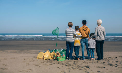 Rear view of people on beach