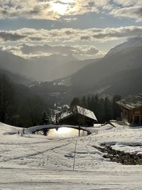 Scenic view of snow covered mountains against sky