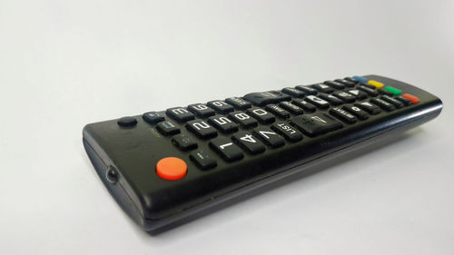 Close-up of computer keyboard on table against white background