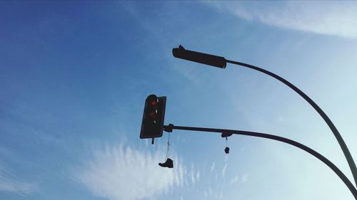 Low angle view of street light against blue sky