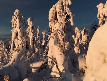 Scenic view of snow covered rock formation against sky