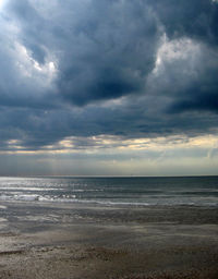 Scenic view of sea against cloudy sky