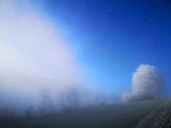 Scenic view of land against clear blue sky