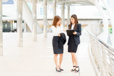 Young woman using mobile phone in office