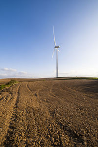 Low angle view of windmill against sky