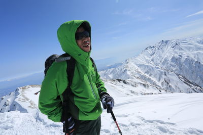 Full length of person on snowcapped mountain against sky