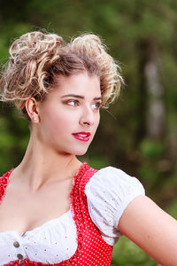 Close-up of young woman looking away while wearing dirndl