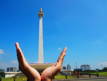 Man tower against blue sky