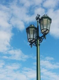 Low angle view of street light against cloudy sky