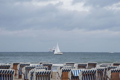 Sailboat sailing on sea against sky