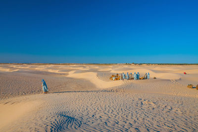 Scenic view of desert against clear blue sky