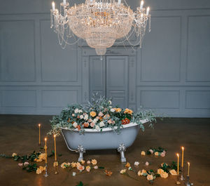 Illuminated chandelier on table at home