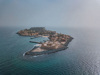 High angle view of island amidst sea against sky