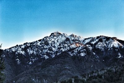 Scenic view of snowcapped mountains against blue sky