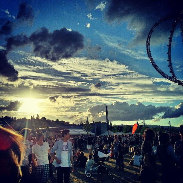 large group of people, leisure activity, sky, lifestyles, enjoyment, men, fun, person, cloud - sky, sun, sunlight, crowd, vacations, sunbeam, blue, cloud, sunset, outdoors, lens flare