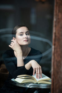 Portrait of woman sitting on table