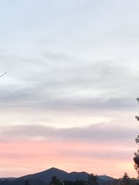 Low angle view of silhouette mountains against sky during sunset