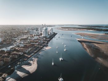 High angle view of sea and city against sky