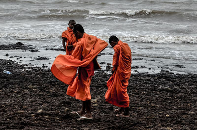 Rear view of two people on beach