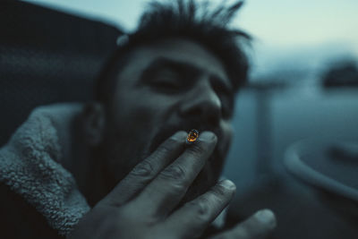 Close-up of young man smoking