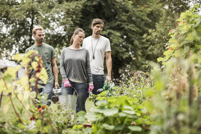 Friends looking at plants in garden