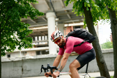 Side view of young woman exercising in park