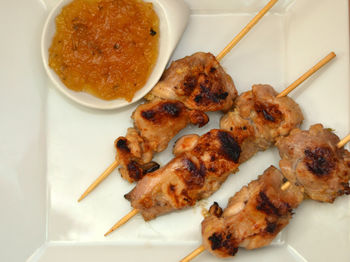 Directly above shot of meat with condiment in plate