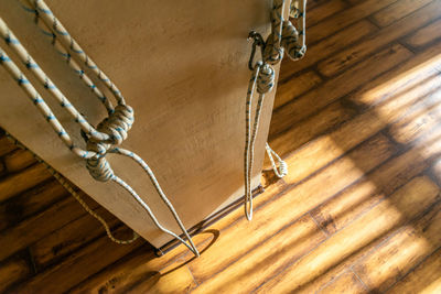 High angle view of rope on hardwood floor