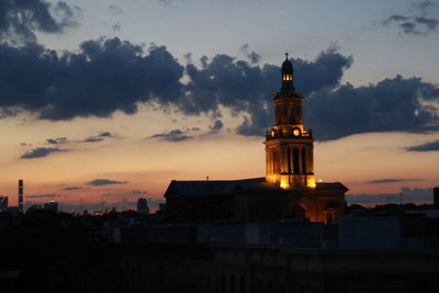 View of tower in city during sunset