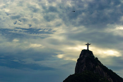 Low angle view of cross against sky