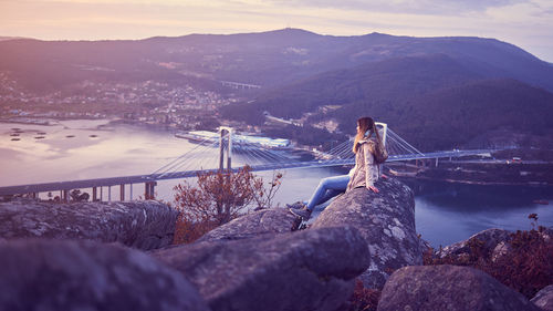 Bridge over river against mountains