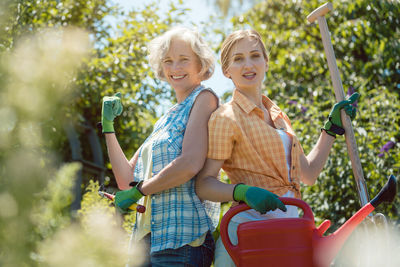 Portrait of smiling girl holding plant