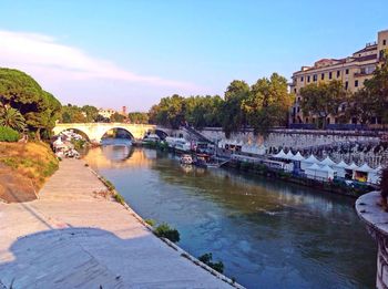 Bridge over river with buildings in background