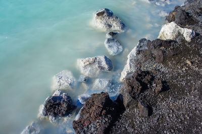 High angle view of rocks in sea