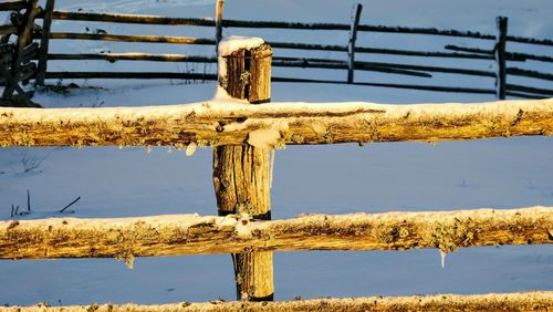 Close-up of wooden post against sky