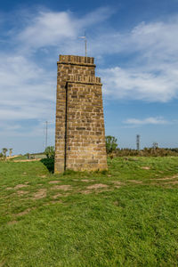 View of tower on field against sky