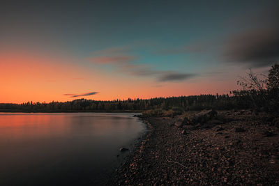 Scenic view of lake against sky during sunset