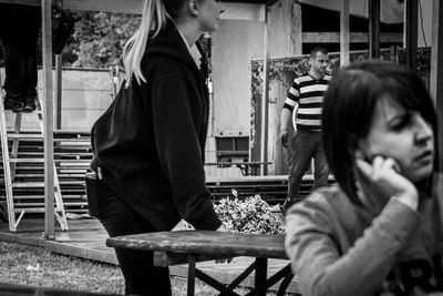 Side view of couple sitting on bench