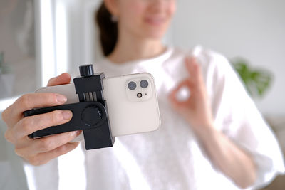 Midsection of woman photographing with camera