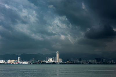 Storm clouds gather over a city at georgetown, pulau pinang malaysia during the southwest monsoon.