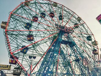 Low angle view of ferris wheel against sky