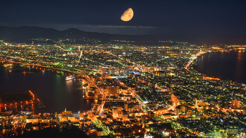 High angle view of illuminated buildings in city at night