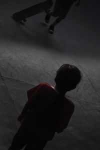 High angle view of boy standing against wall at home